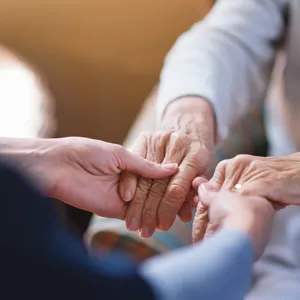 A close-up of hands holding each other