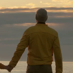 A man and woman walking on a beach