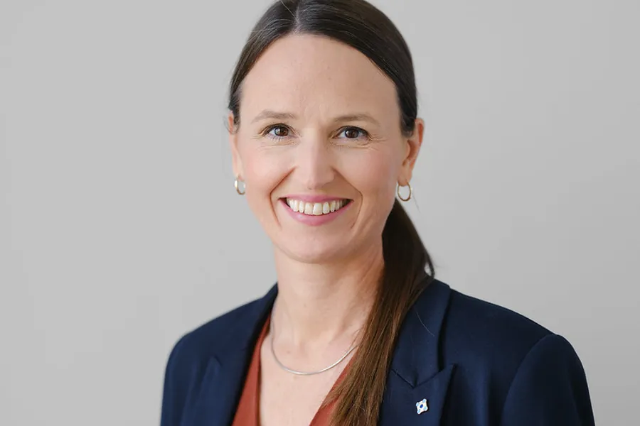 En kvinne som smiler til kameraet