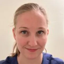 En kvinne som smiler til kameraet