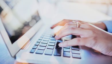 A person typing on a laptop