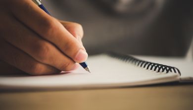 A hand holding a pen