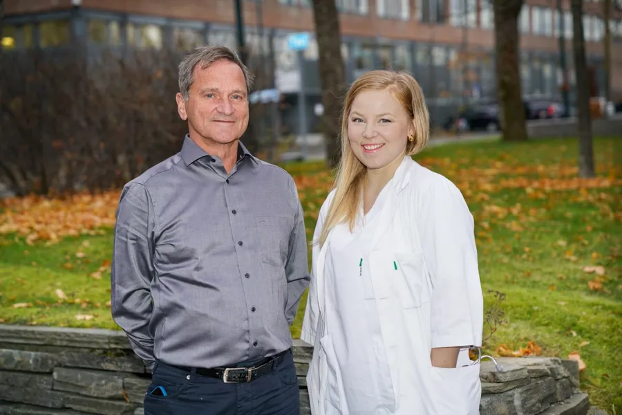 A man and a woman standing next to each other outside